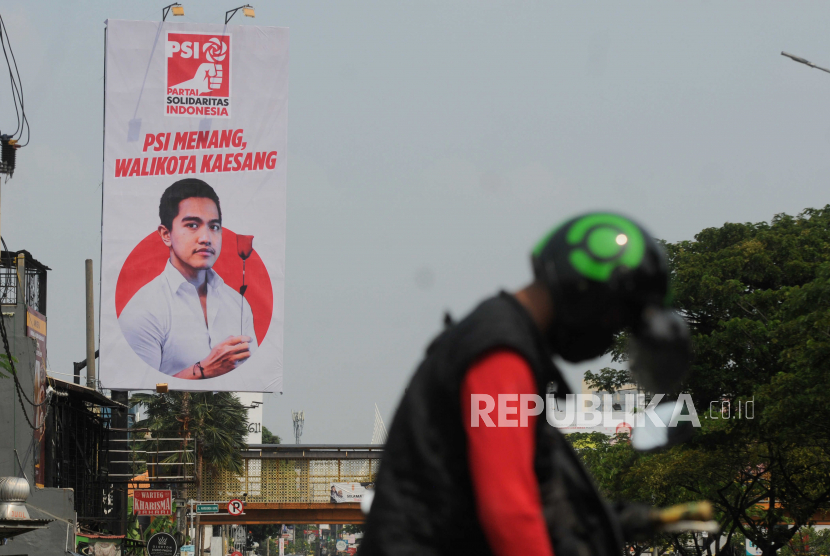 Pengendara motor berhenti di dekat baliho bergambar putra Presiden Joko Widodo, Kaesang Pangarep yang dipasang PSI di Jalan Margonda Raya, Kota Depok, Jawa Barat, Selasa (23/5/2023).