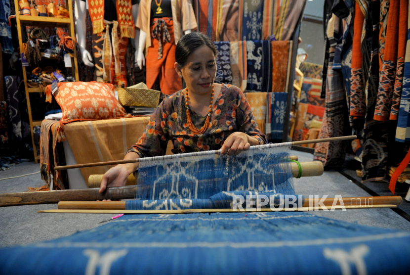 Pengrajin menyelesaikan pembuatan kain tenun pada gelaran International Handicraft Trade Fair (Inacraft) on October 2023 di Jakarta Convention Center, Jakarta, Sabtu (7/10/2023). Inacraft 2023 kembali digelar dengan menyajikan sebanyak 772 stan produk kerajinan UMKM dari dalam negeri hingga luar negeri yang berlangsung hingga besok 8 Oktober 2023.