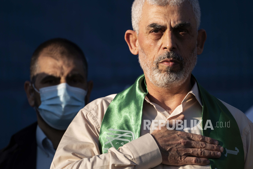 Yahya Sinwar, Palestinian leader of Hamas in the Gaza Strip, places his hand over his heart on stage after greeting supporters at a rally of supporters days after a cease-fire was reached in an 11-day war between Gaza