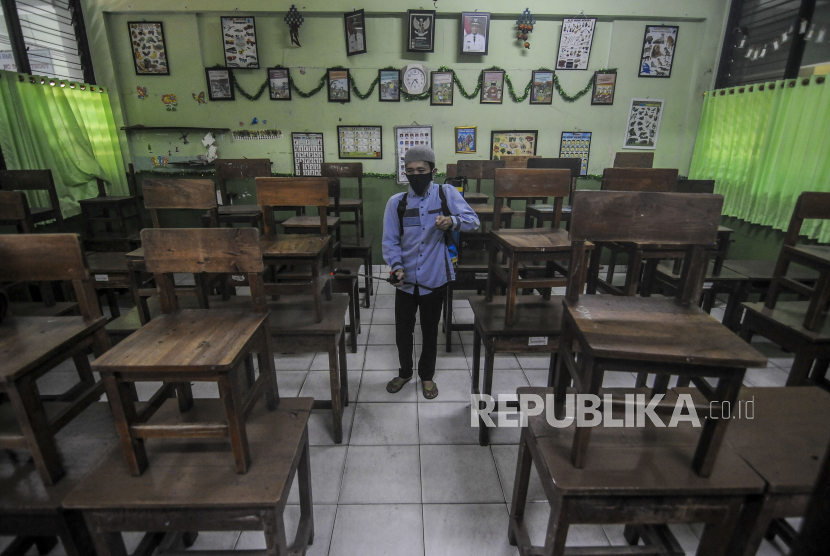 Yogyakarta Susun Buku Panduan KBM Tatap Muka Terbatas. Petugas menyemprotkan cairan disinfektan di ruang kelas. Ilustrasi