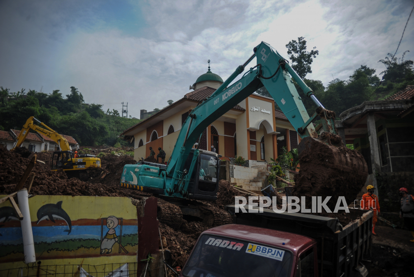 Petugas SAR gabungan mengoperasikan alat berat untuk melakukan pencarian korban bencana tanah longsor di Cimanggung, Kabupaten Sumedang, Jawa Barat, Kamis (14/1/2021). Hingga pagi hari di hari keenam pencarian, tim SAR gabungan telah menemukan 22 korban bencana tanah longsor yang terjadi pada Sabtu (9/1) lalu. 