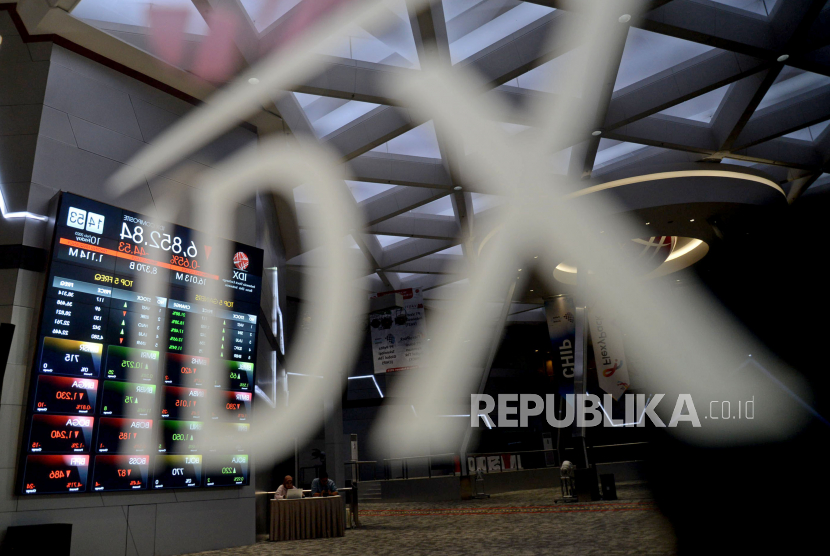 Karyawan berada di dekat papan pergerakan saham di Gedung Bursa Efek Indonesia (BEI), Jakarta, Jumat (10/2/2023).