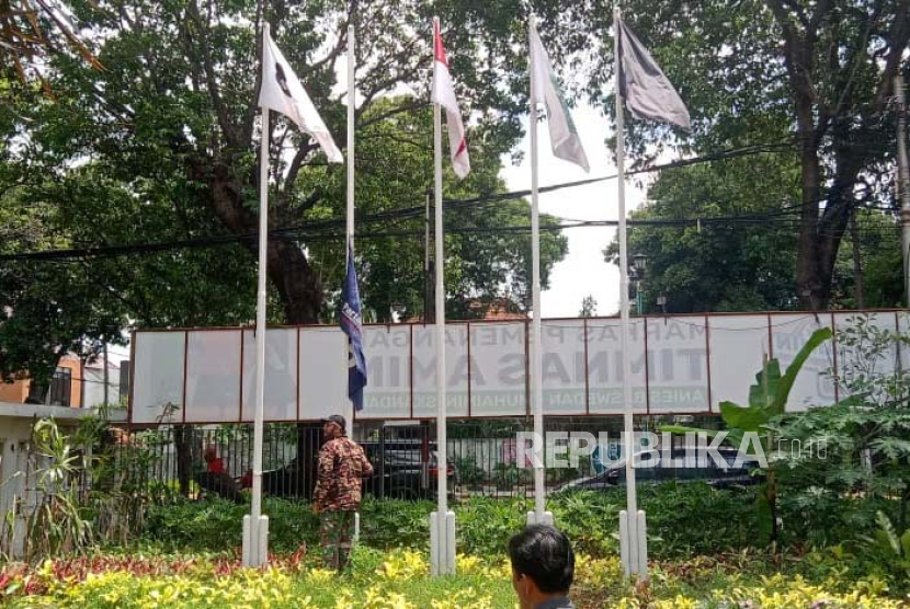 Seorang relawan AMIN tengah menurunkan bendera Partai Nasdem karena mengaku kecewa pada sikap elite Partai Nasdem dalam menanggapi hasil Pilpres di Markas Pemenangan AMIN, Jalan Diponegoro 10, Menteng, Jakarta Pusat, Kamis (21/3/2024). 