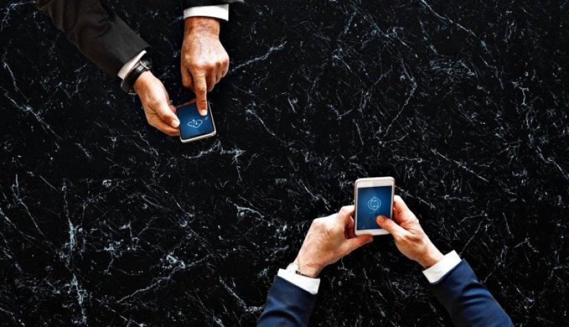 Two men operating smartphones. (Unsplash/Rawpixel)