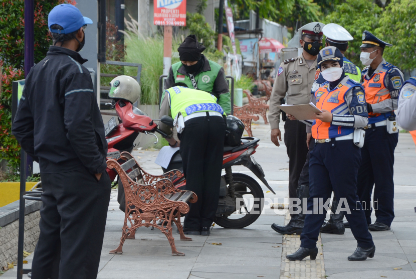 Petugas Dinas Perhubungan (Dishub) Kota Bandung bersama petugas kepolisian melakukan penertiban sepeda motor yang parkir sembarangan di trotoar, Jalan LRE Martadinata, Kota Bandung.