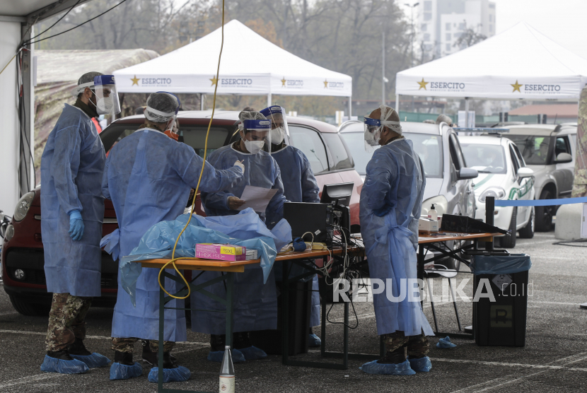 Personel medis Angkatan Darat, yang mengenakan pakaian pelindung, bekerja di area pengujian cepat virus korona yang disiapkan untuk meredakan tekanan di bangsal darurat rumah sakit, menyusul lonjakan jumlah kasus COVID-19, di Milan, Italia, Jumat, 13 November 2020.