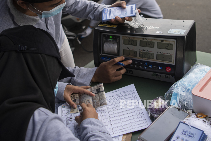 Petugas mencatat hasil uji emisi kendaraan di Jalan Benyamin Sueb, Pademangan, Jakarta Utara, Selasa (28/6/2022). Pemerintah Kota Jakarta Utara menggelar uji emisi gratis untuk kendaraan bermotor selama tiga hari sebagai bagian dari rencana pengelolaan kualitas udara perkotaan. 