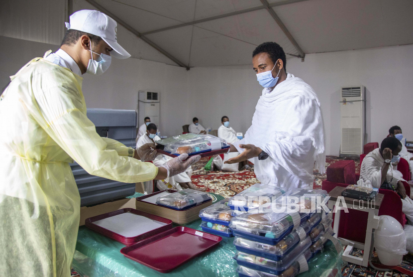 Jamaah Haji Disarankan Konsumsi Produk Organik. Foto: Jamaah haji makan di kamp mereka selama ziarah tahunan haji di dekat kota suci Mekah, Arab Saudi, Kamis, 30 Juli 2020. Hanya sekitar 1.000 peziarah akan diizinkan untuk melakukan ziarah haji tahunan tahun ini karena pandemi virus.