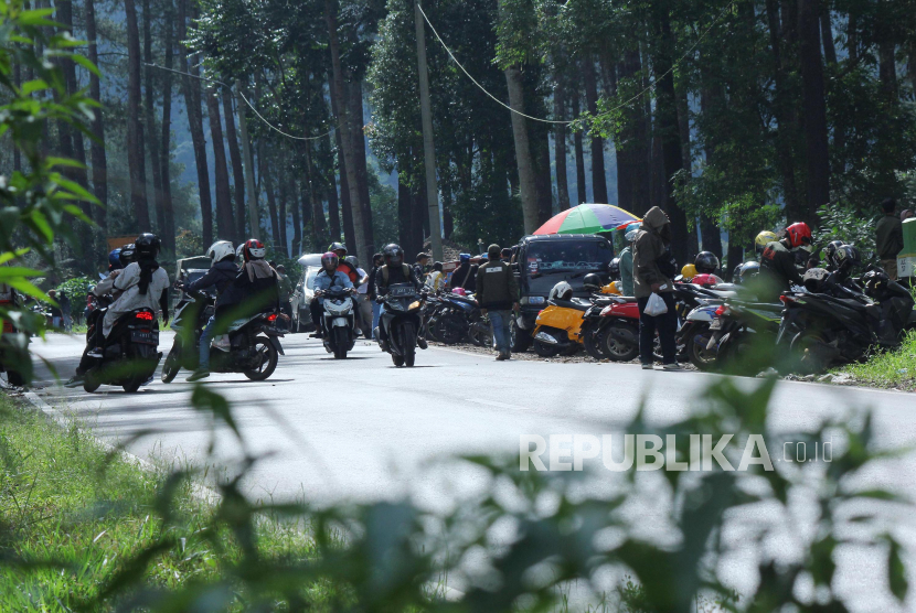 Sejumlah kendaraan parkir di depan kawasan wisata hutan pinus di kawasan Bandung, Jawa Barat.