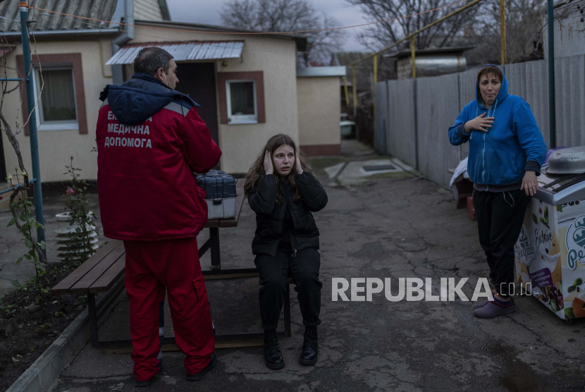 Warga bereaksi selama pemogokan Rusia di Kherson, Ukraina selatan, Selasa, 22 November 2022. Ketika serangan meningkat di kota Kherson yang baru saja dibebaskan, para dokter berjuang untuk mengatasi kekurangan air, listrik, dan kurangnya peralatan.