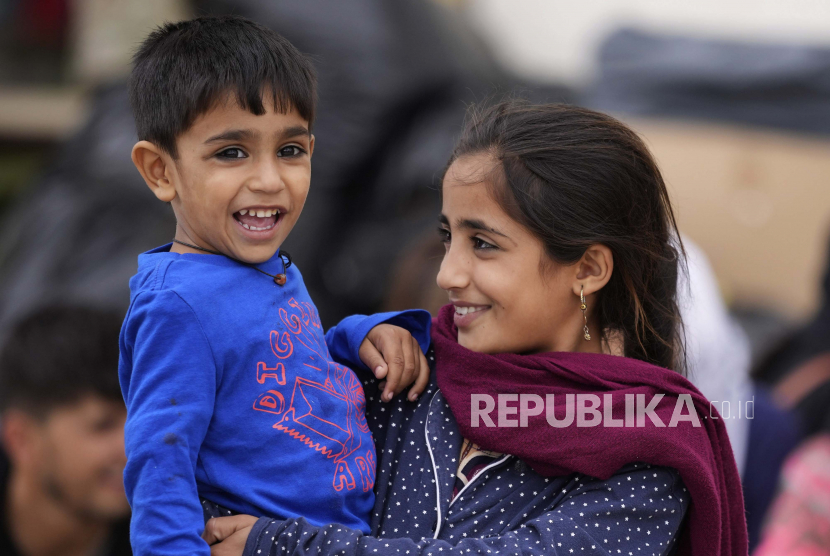 Anak-anak Afghanistan yang baru dievakuasi tertawa di Pangkalan Udara AS Ramstein, Jerman, Selasa, 24 Agustus 2021. Komunitas militer Amerika terbesar di luar negeri menampung ribuan pengungsi Afghanistan di kota tenda yang semakin padat.