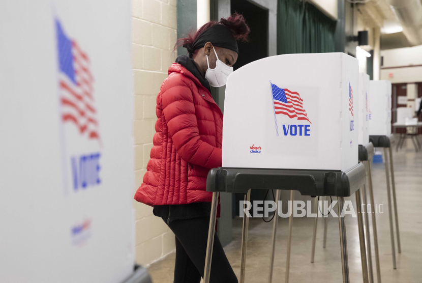 Seseorang berdiri di bilik pemungutan suara sambil bersiap untuk memberikan surat suara di lokasi pemungutan suara di dalam Show Place Arena di Upper Marlboro, Maryland, AS, 02 November 2020. 
