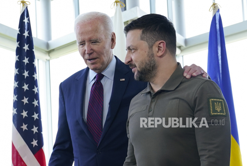  Presiden Joe Biden (kiri) berjalan bersama Presiden Ukraina Volodymyr Zelenskyy.