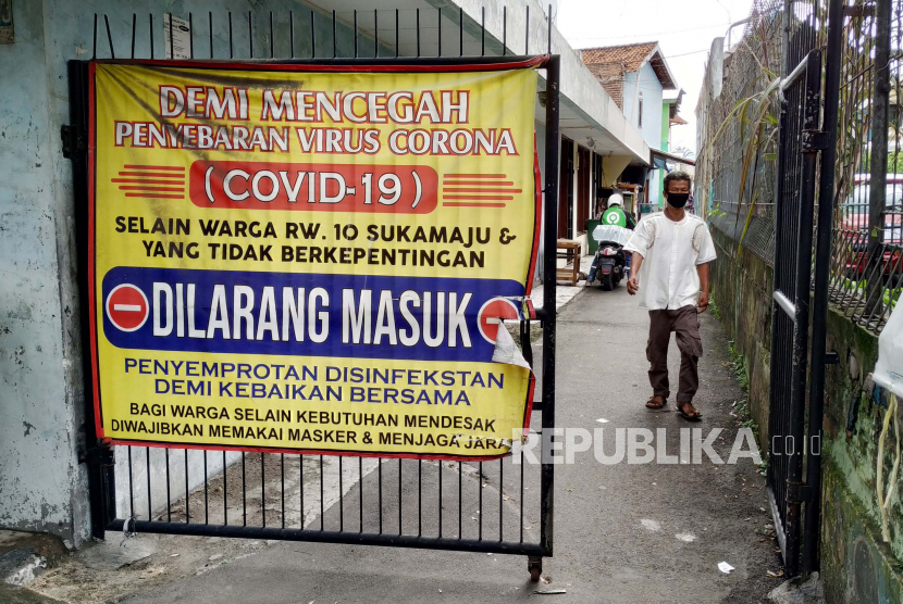 Pemberlakuan Pembatasan Kegiatan Masyarakat (PPKM) Mikro di salah satu gang, Jalan Ahmad Yani, Kota Bandung, Senin (28/6). Pemkot Bandung terus meningkatkan pengawasan penanganan Covid-19 yang tertuang dalam Peraturan Wali Kota (Perwal) Nomor 61 Tahun 2021 tentang PPKM Mikro. Hal tersebut sebagai upaya mencegah lonjakan kasus Covid-19 di Kota Bandung yang saat ini masuk zona merah.