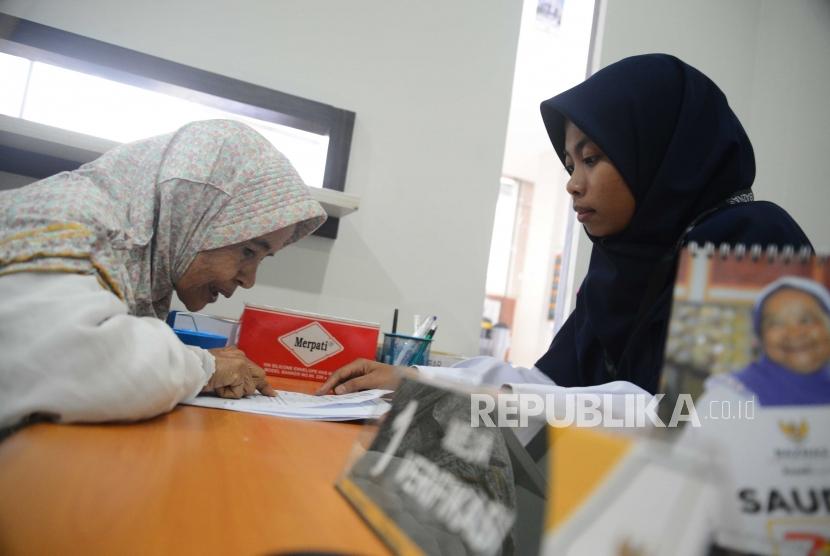 Petugas Badan Amil Zakat Nasional,melakukan verifikasi  warga yang  datang ke kantor Baznas Tebet, Jakarta, Selasa (26/6).