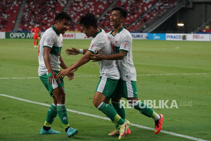 Pesepak bola timnas Indonesia Witan Sulaeman (tengah), Pratama Arhan (kanan), dan Asnawi Mangkualam (kiri) berselebrasi usai menjebol gawang timnas Singapura dalam pertandingan semifinal leg 1 Piala AFF 2020 di National Stadium, Singapura, Rabu (22/12/2021).  Kedua tim bermain imbang 1-1.