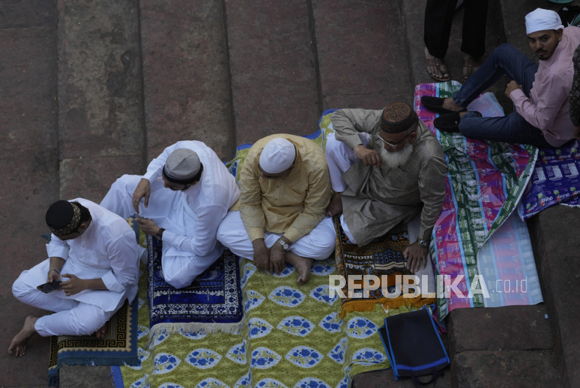 Umat ​​Muslim duduk di tangga masjid Jama setelah melaksanakan sholat Idul Fitri di New Delhi, India, Kamis, 11 April 2024.