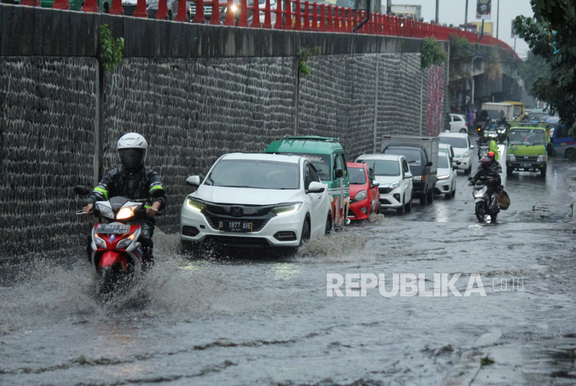 Kendaraan melewati genangan cileuncang atau genangan air hujan yang merendam ruas jalan di bawah Flyover Cimindi, Kota Cimahi, Jumat (16/6/2023). 