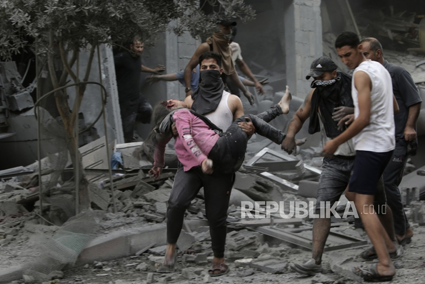 Pria menggotong anak perempuan usai serangan udara di Gaza bagian utara pada Sabtu (28/10/2023). Lebih dari 7.000 warga Palestina dan 1.300 warga Israel meninggal sejak serangan 7 Oktober tahun ini.