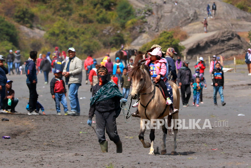 Pengunjung naik kuda yang disewakan di Tengger, Gunung Bromo, Probolinggo, Jawa Timur, Selasa (7/7/2020). Pemilik kuda mengaku, pada ritual Yadnya Kasada tahun ini omsetnya menurun karena perayaannya hanya diikuti warga Tengger saja. 