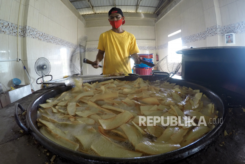 Pekerja menggoreng singkong untuk diolah menjadi keripik balado di Dapur Christine Hakim, Padang, Sumatera Barat, Jumat (16/10/2020). Usaha kripik balado yang merupakan oleh-oleh khas Kota Padang itu masih bertahan di tengah pandemi COVID-19, dengan mengurangi produksi hingga 60 persen dan memanfaatkan promosi dan penjualan secara daring. 