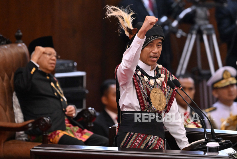 Indonesian President Joko Widodo, wearing a traditional outfit from Tanimbar, Maluku province, shouts 