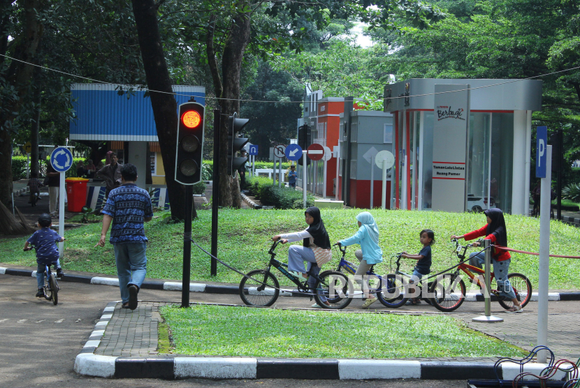 Pengunjung bermain sepeda dengan mengikuti rambu lalu lintas di tempat wisata Taman Lalu Lintas Ade Irma Suryani Nasution, di Jalan Belitung, Kota Bandung, Jawa Barat, Senin (25/12/2023). 