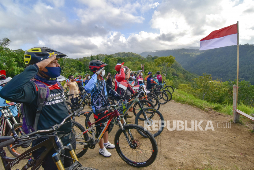 Sejumlah pehobi sepeda gunung mengikuti upacara bendera memperingati Hari Kemerdekaan RI di Bukit Cacing, Dusun Medas Bentaur, Desa Tamansari, Kecamatan Gunungsari, NTB. Lombok Tengah, NTB mendorong gerakan 10 juta bendera merah putih.
