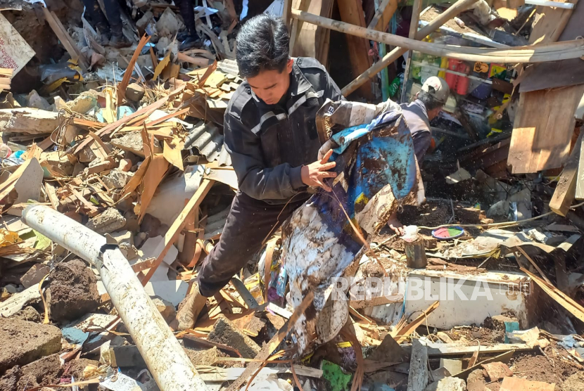 Petugas bersama warga membersihkan sisa lumpur akibat pipa PDAM yang jebol di RT 01 RW 05 Jalan Maleer, Kota Bandung, Jawa Barat,Kamis (6/6/2024). Pemilik rumah yang rusak berat berusaha mencari barang-barang berharga yang masih bisa diselamatkan. 