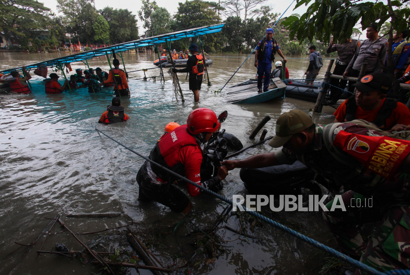 Petugas gabungan mengevakuasi sepeda motor dari perahu tambang yang tenggelam di sungai di Mastrip, Surabaya, Jawa Timur, Sabtu (25/3/2023). Alat transportasi penyeberangan sungai yang diduga mengalami kebocoran itu tenggelam dan mengakibatkan satu orang hilang sementara 12 penumpang lainnya selamat. 
