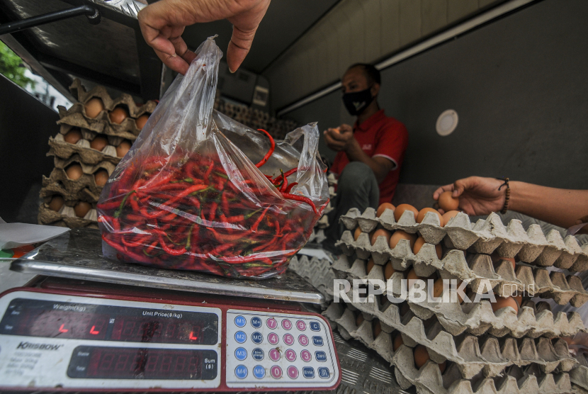 Petugas menimbang cabai yang dijual saat Gelar Pangan Murah di Pasar Cempaka Putih, Jakarta, Senin (28/12).