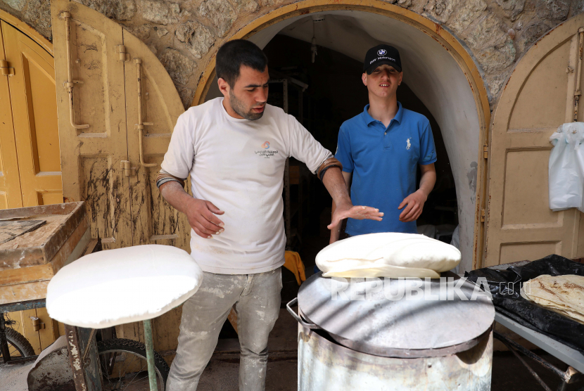 Seorang tukang roti Palestina menyiapkan roti Saj di kota Hebron Tepi Barat, Ahad (26/4). Pandemi Covid-19 di Palestina berdampak negatif terhadap sektor UKM. Ilustrasi.