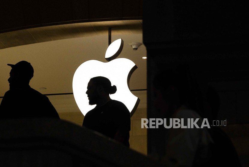  Warga melintas di depan logo Apple pada Apple Store, New York, AS pada 4 Maret 2024.  