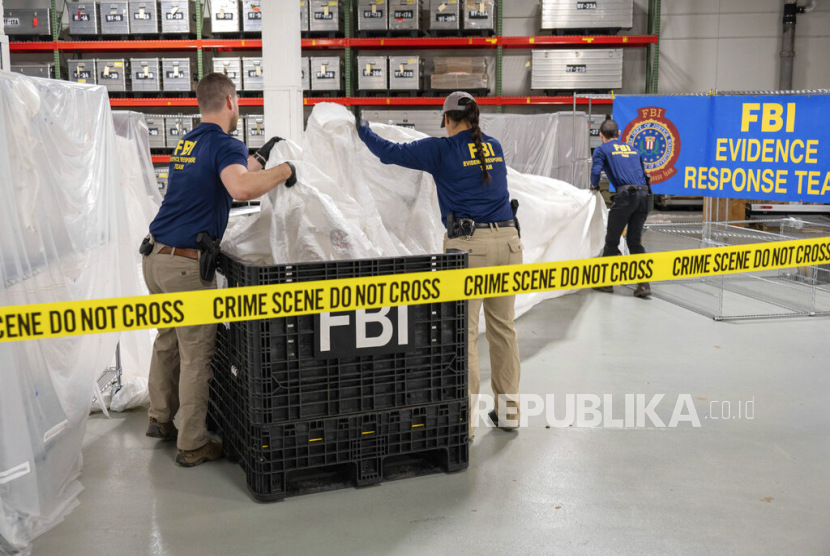  Dalam gambar yang disediakan oleh FBI ini, agen khusus FBI yang ditugaskan ke tim respons bukti memproses materi yang diambil dari balon mata-mata China yang ditemukan di lepas pantai Carolina Selatan, Kamis (9/2/2023), di laboratorium FBI di Quantico, Va.
