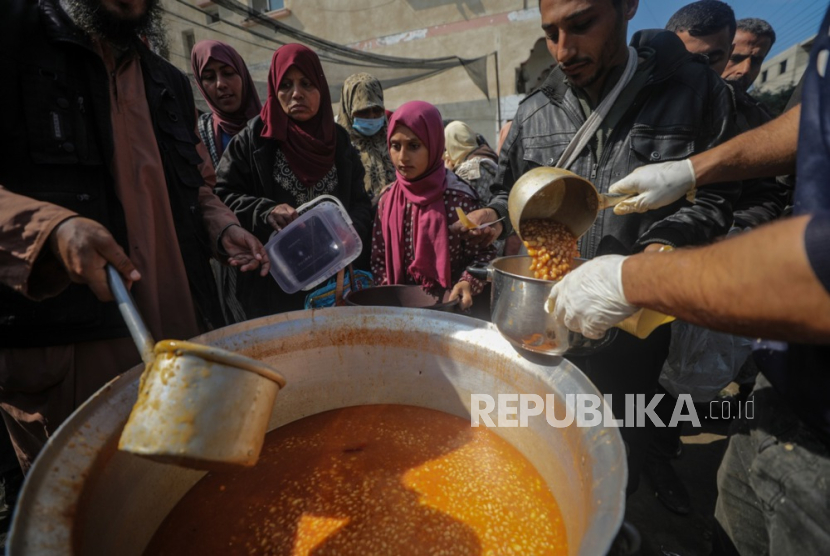 Anak-anak pengungsi Palestina antre untuk menerima makanan yang disediakan oleh relawan di kota Deir Al Balah, Jalur Gaza Selatan, Sabtu (24/2/2024). Sebanyak 1,9 juta orang telah mengungsi di Gaza akibat konflik berkepanjangan. Badan Bantuan dan Pekerjaan PBB untuk Pengungsi Palestina (UNRWA) menyatakan sebagian besar warga sipil di Gaza sangat membutuhkan bantuan kemanusiaan.