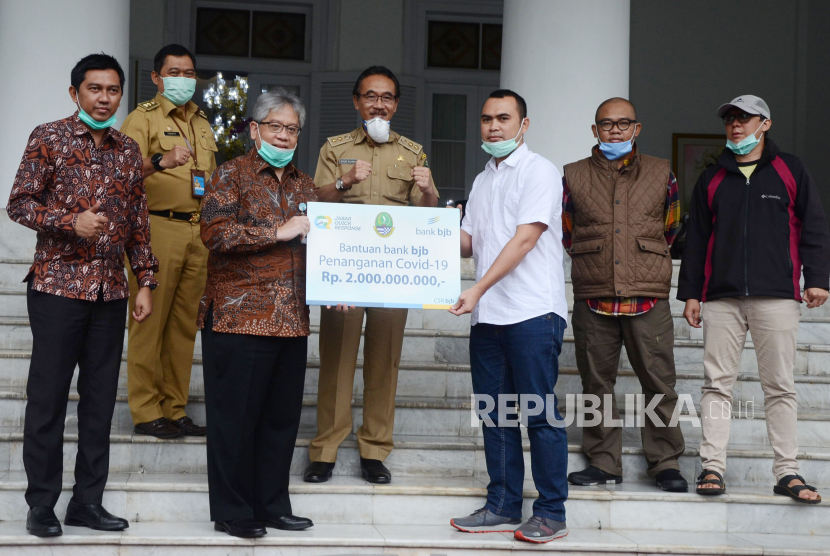 Dirut Bank BJB Yuddy Renaldi menyerahkan bantuan CSR Penanganan Covid-19 senilai dua miliar kepada Provinsi Jawa Barat melalui Jabar Quick Response di Gedung Pakuan, Kota Bandung, Senin (23/3). 