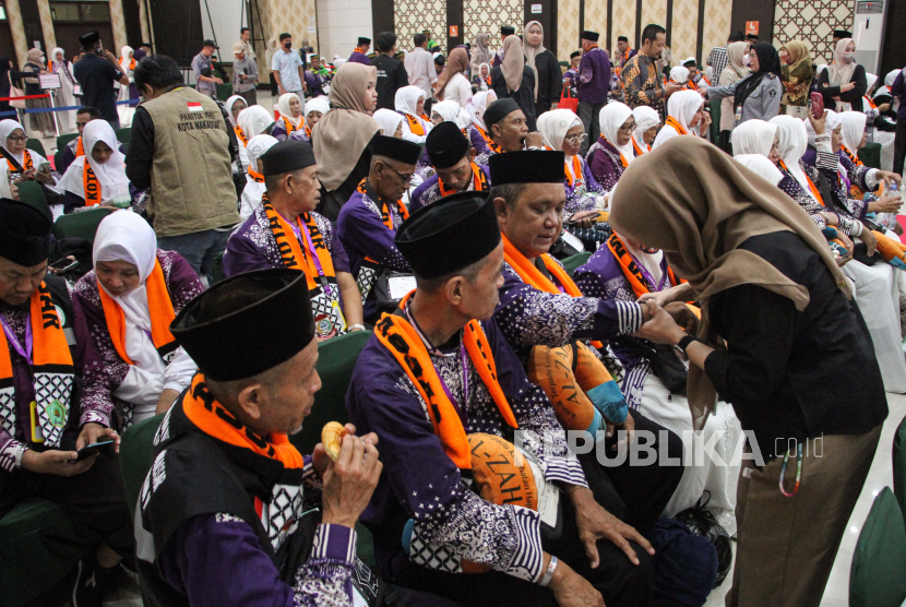 Petugas memasangkan gelang kepada Jemaah Calon Haji (JCH) kelompok terbang (kloter) pertama embarkasi Makassar di Asrama Haji Sudiang, Makassar, Sulawesi Selatan, Sabtu (11/5/2024). Sebanyak 442 JCH yang tergabung dalam kloter pertama embarkasi Makassar didampingi delapan orang petugas haji daerah dan petugas kloter telah masuk asrama haji setempat yang dijadwalkan akan berangkat ke Arab Saudi pada Minggu (12/5) melalui Bandara Internasional Sultan Hasanuddin. 