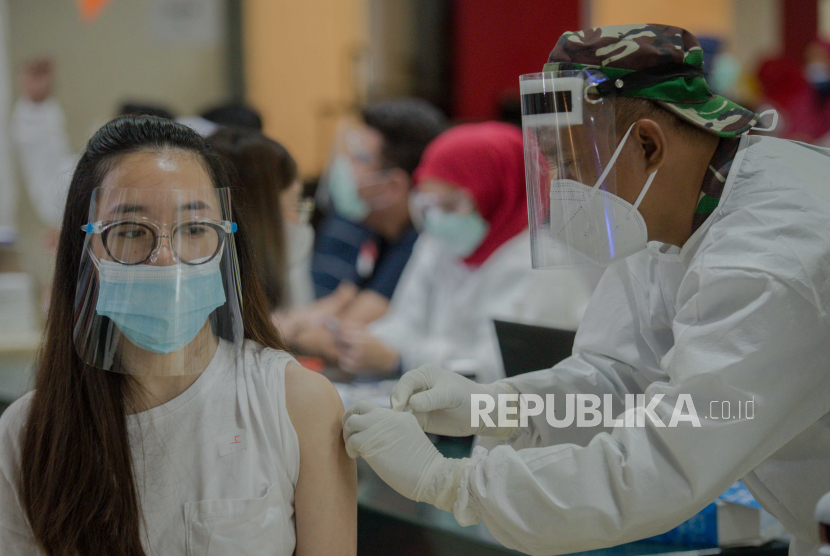 Vaksinator menyuntikan vaksin Covid-19 kepada pedagang pasar Tanah Abang di Pasar Tanah Abang Blok A, Jakarta, Rabu (17/1).