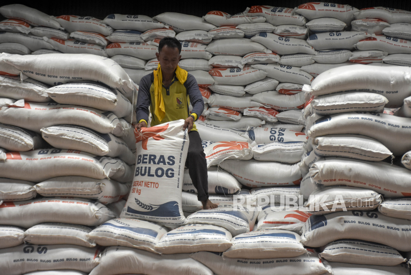 Pekerja mengangkut beras di Gudang Baru Bulog Cisaranten Kidul, Gedebage, Kota Bandung, Senin (30/1/2023). Bulog Cabang Bandung menggelontorkan 3.000 ton beras medium ke pasar-pasar tradisional di wilayah Bandung Raya dan Sumedang guna menstabilkan harga. Harga beras medium bagi pedagang sebesar Rp8.300 per kilogram, sementara untuk konsumen maksimal di harga eceran tertinggi (HET) sebesar Rp9.450 per kilogram.