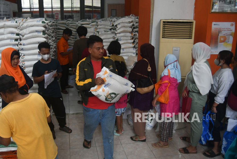 Warga penerima manfaat membawa beras saat penyaluran bantuan sosial (Bansos) cadangan beras pemerintah di Kantor Pos Bogor, Jawa Barat, Selasa (12/3/2024). 