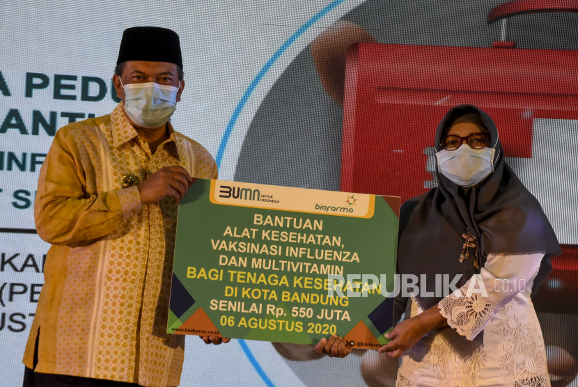 Wali Kota Bandung Oded M Danial (kiri) menyerahkan bantuan kepada Kepala Dinas Kesehatan Kota Bandung Rita Verita (kanan).