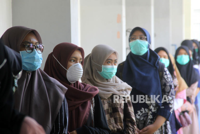 Sejumlah peserta mengantre sebelum masuk ke ruangan Ujian Tertulis Berbasis Komputer (UTBK) di Fakultas Teknik Universitas Lambung Mangkurat Banjarmasin, Kalimantan Selatan, Minggu (5/7/2020). Universitas Lambung Mangkurat mengadakan UTBK yang merupakan tahapan yang harus dilalui calon mahasiswa untuk melihat kemampuan sebelum mengikuti Seleksi Bersama Masuk Perguruan Tinggi Negeri (SBMPTN) 2020 dengan menerapkan protokol kesehatan secara ketat untuk mencegah penyebaran pandemi COVID-19. 