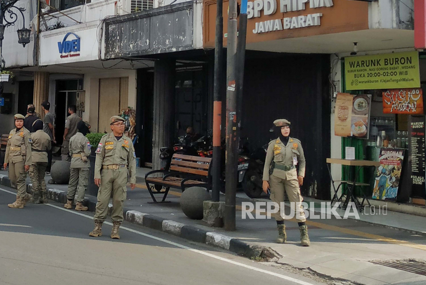 Para petugas Satpol PP Kota Bandung berjaga di Jalan Braga dan kawasan Alun-alun Kota Bandung, Selasa (23/5/2023). 