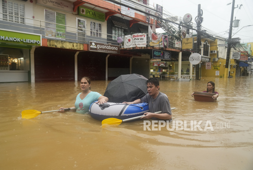 Warga mengevakuasi barang saat terjadi banjir di Filipina (ilustrasi). Lebih dari 1,8 juta orang terdampak oleh topan di seluruh Filipina selama bulan lalu