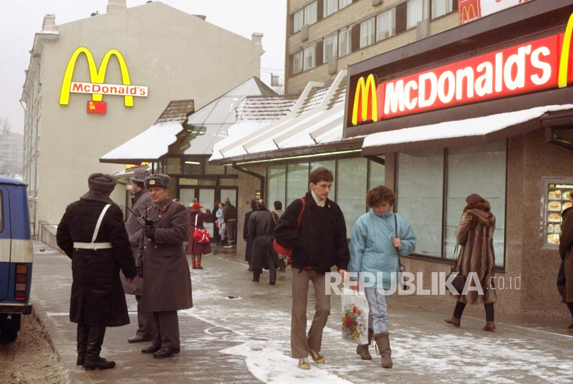  FILE - Orang-orang berjalan melewati McDonalds pertama di Moskow sehari sebelum pembukaannya, di Lapangan Pushkin Moskow, 30 Januari 1990. 
