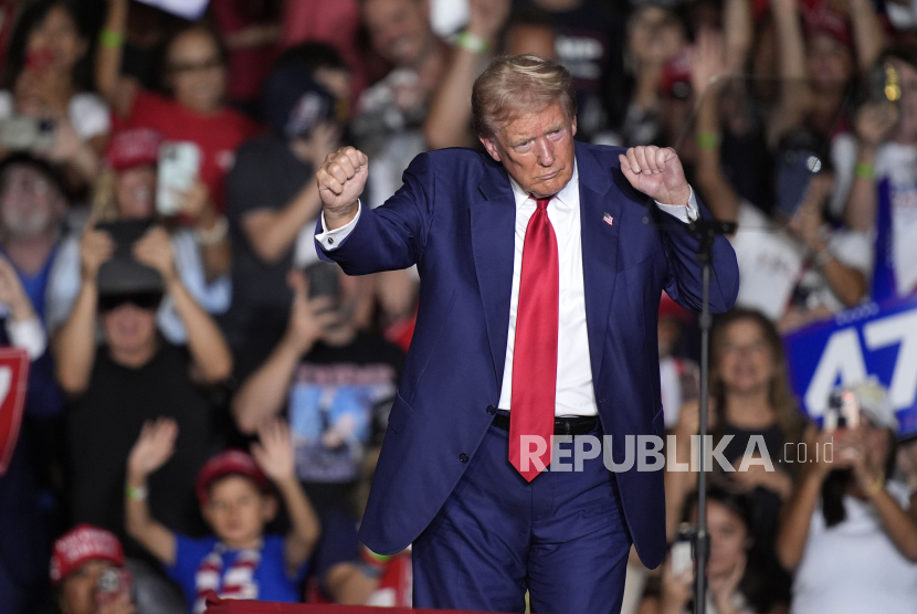 Republican presidential nominee former President Donald Trump dances as he departs a campaign event at the World Market Center, Friday, Sept.13, 2024, in Las Vegas. 