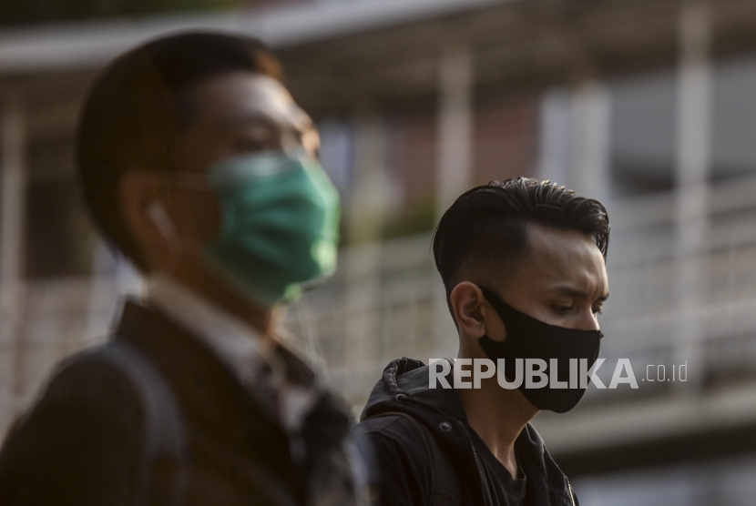Warga menggunakan masker scuba saat berjalan (ilustrasi). Pemprov Jawa Barat sudah berkonsultasi dengan Balai Besar Tekstil terkait penggunaan bahan scuba untuk masker.