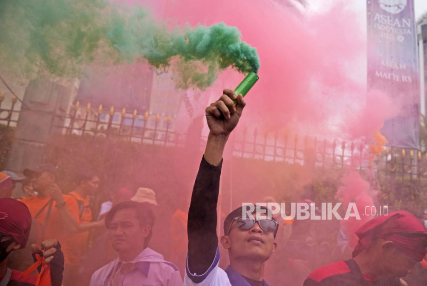  Seorang pekerja mengangkat tongkat asap saat unjuk rasa May Day di Jakarta, Senin (1/5/2023). Pekerja dan aktivis di seluruh Asia menandai May Day dengan protes menyerukan gaji yang lebih tinggi dan kondisi kerja yang lebih baik, di antara tuntutan lainnya. Tak hanya pekerja dan buruh, dosen dan tenaga didik pun disarankan untuk berserikat agar dapat menyuarakan haknya secara bersama-sama/ilustrasi.