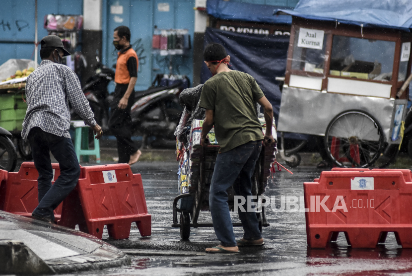 Pedagang menerobos pembatas jalan di kawasan Jalan Otto Iskandar Dinata (Otista), Kota Bandung, Senin (18/5). 