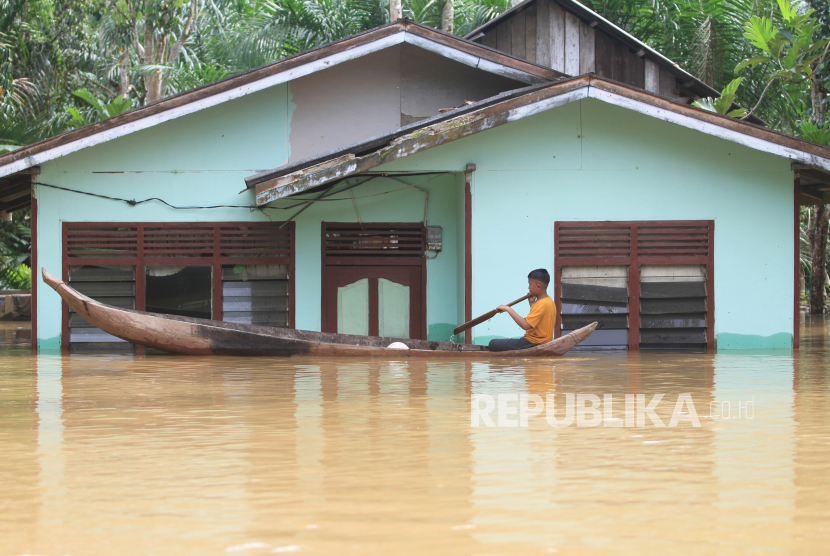 Seorang anak naik perahu saat melintasi banjir di Desa Napai, Woyla Barat, Aceh Barat, Aceh, Sabtu (5/11/2022). Tujuh Kabupaten/Kota di Aceh Berstatus Siaga Banjir